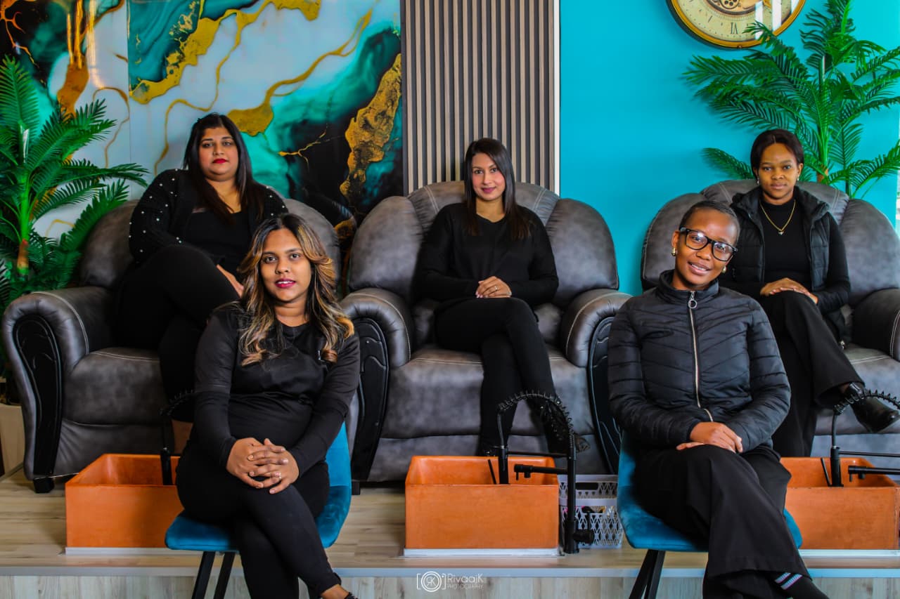 Changing Faces team seated together in the salon
